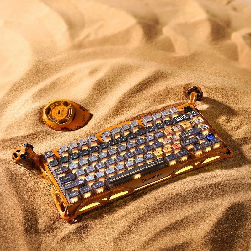 GravaStar Mercury K1 Pro Battle Worn Yellow keyboard angled on sand